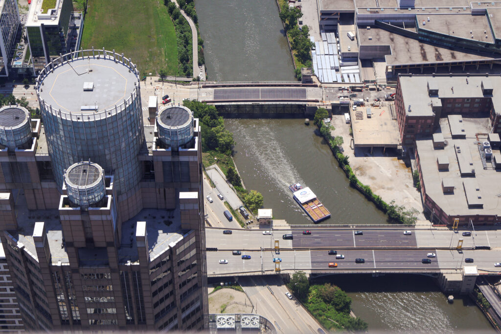 View from Willis Tower looking at a river with a boat passing between two bridges