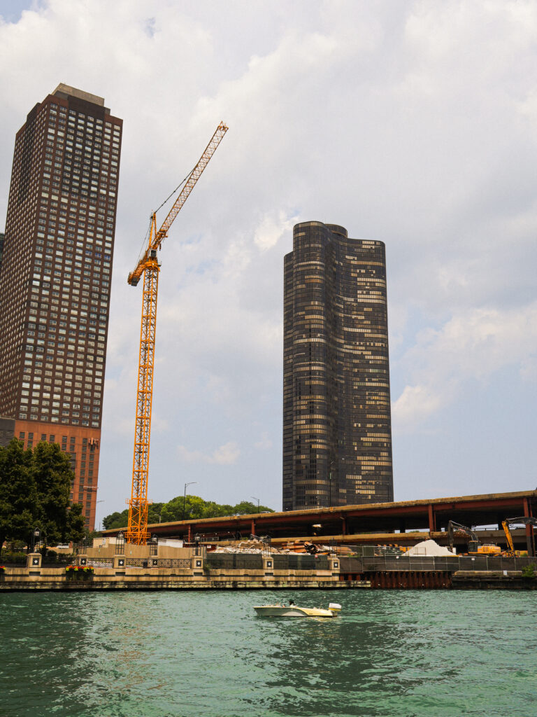 vertical landscape of two skyscrapers and a crane in chicago