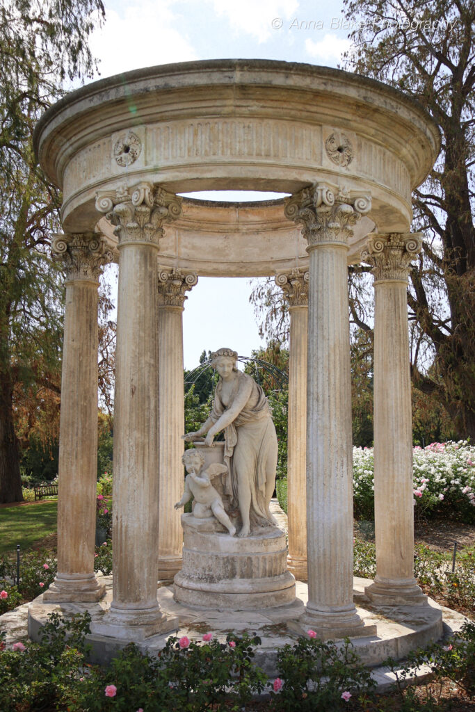 Statue of a woman and a child with wings in a cylindrical dome